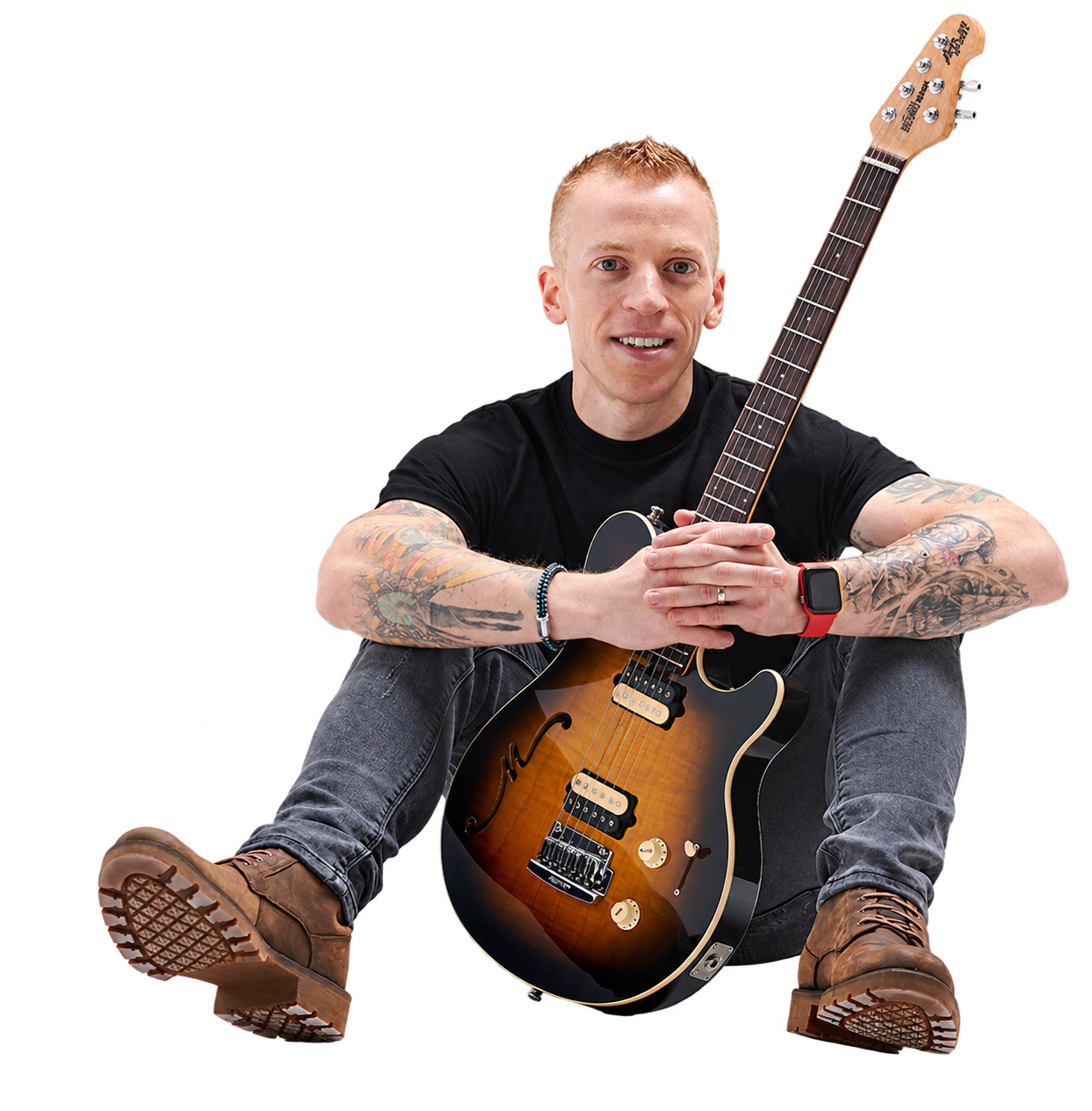 Richard Hillyer seated with his guitar
